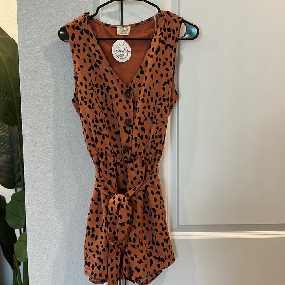 NWT Peach Love Romper. Size Large. Never worn. Orange tan color.